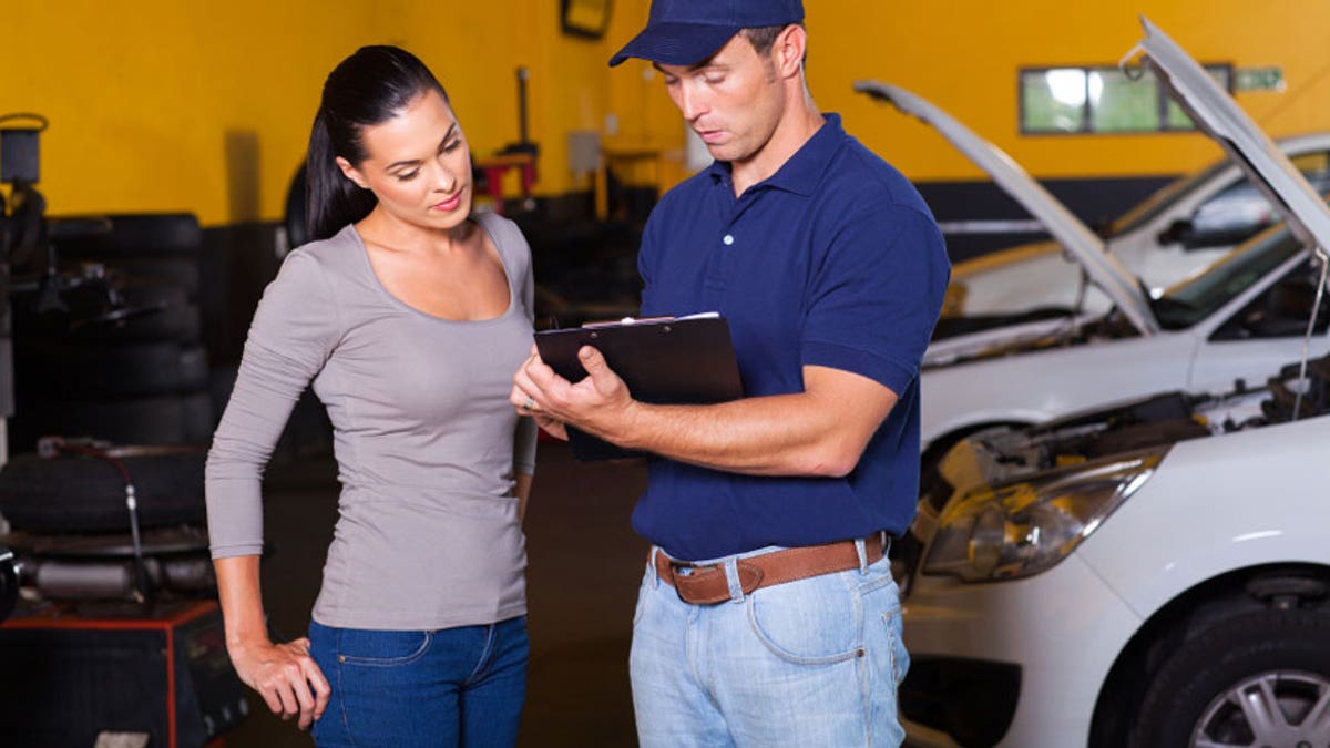 auto mechanic and young woman in workshop