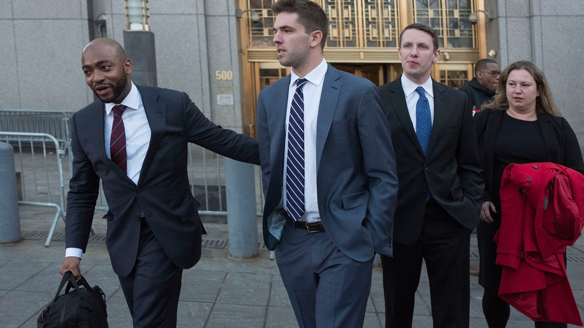 Billy McFarland, center, accompanied by his attorney Randall Jackson, left, leaves federal court after pleading guilty to wire fraud charges, Tuesday, March 6, 2018, in New York. The promoter of the failed Fyre Festival in the Bahamas faces a sentence of 8 to 10 years. (AP Photo/Mark Lennihan)