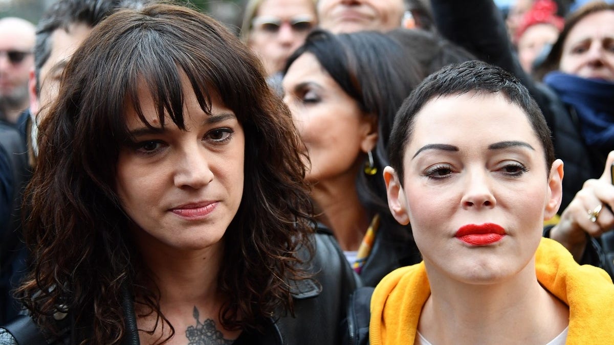 Italian actress Asia Argento (L) and US singer and actress Rose McGowan, who both accuse Harvey Weinstein of sexual assault, take part in a march organised by 'Non Una Di Meno' (Me too) movement on March 8, 2018 as part of the International Women's Day in Rome. 
'Non Una Di Meno', which translates as Not One (Woman) Less, is the equivalent of the movement that grew out of the Harvey Weinstein-spurred sexual harassment and rape revelations.  / AFP PHOTO / Alberto PIZZOLI        (Photo credit should read ALBERTO PIZZOLI/AFP/Getty Images)