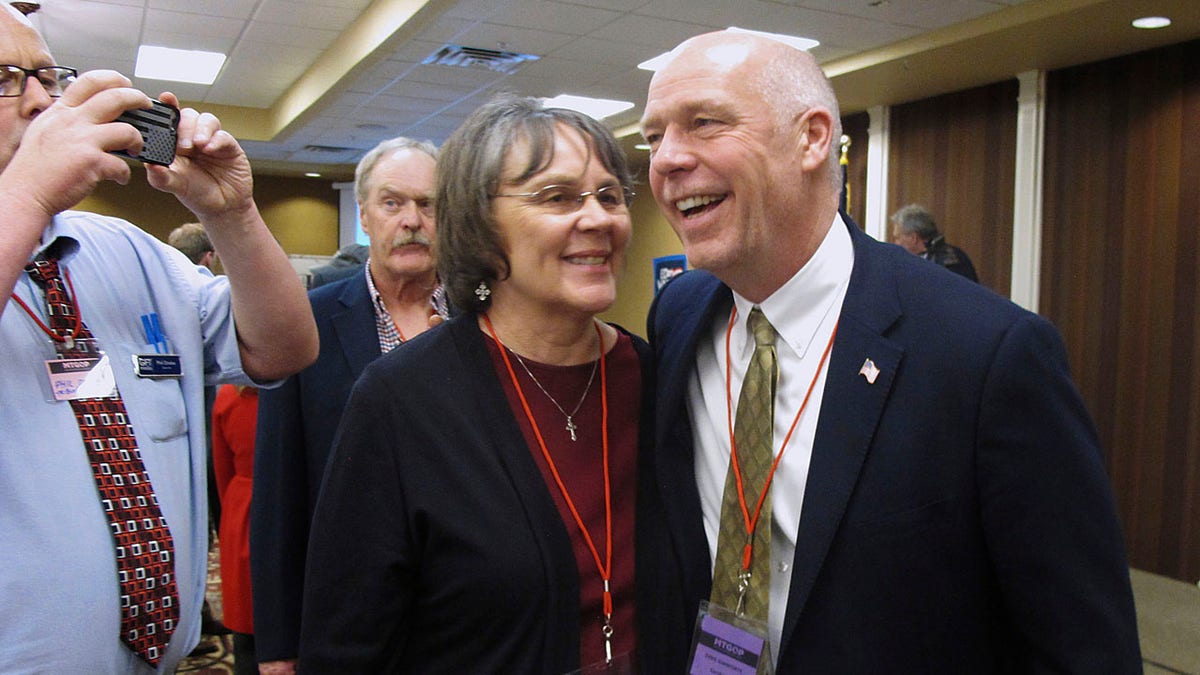 FILE - In this March 6, 2017, file photo, Greg Gianforte, right, receives congratulations from a supporter in Helena, Mont. Montana voters are heading to the polls Thursday, May 25, 2017, to decide a nationally watched congressional election amid uncertainty in Washington over President Donald Trump's agenda and his handling of the country's affairs. (AP Photo/Matt Volz, File)