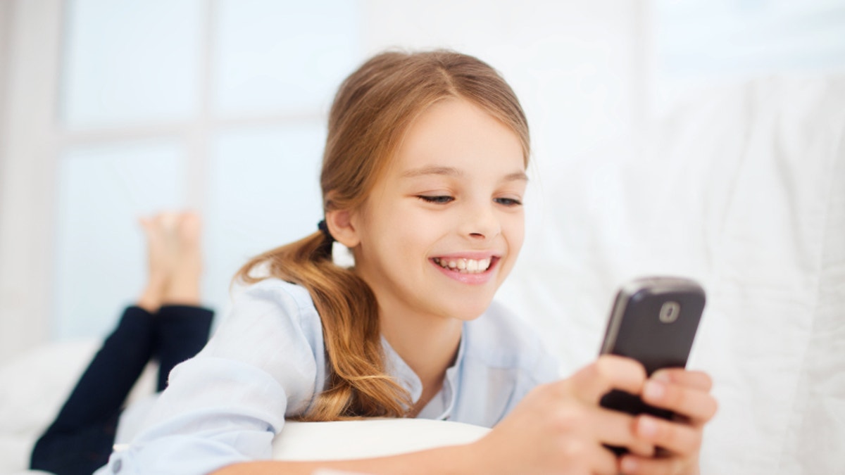 girl with smartphone at home