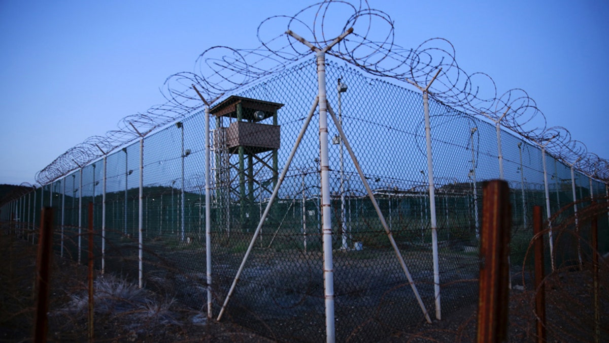 FILE PHOTO - Chain link fence and concertina wire surrounds a deserted guard tower within Joint Task Force Guantanamo's Camp Delta at the U.S. Naval Base in Guantanamo Bay, Cuba March 21, 2016. REUTERS/Lucas Jackson/File Photo - S1AETVRIRPAA