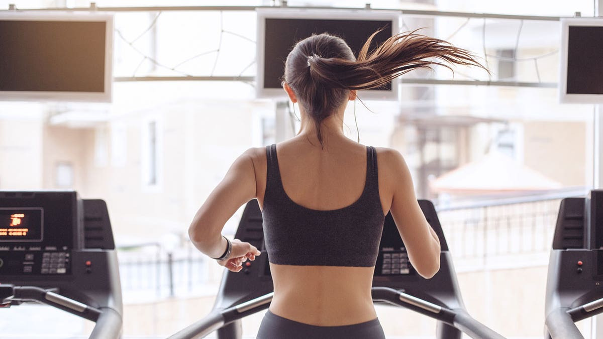 gym treadmill tv woman istock