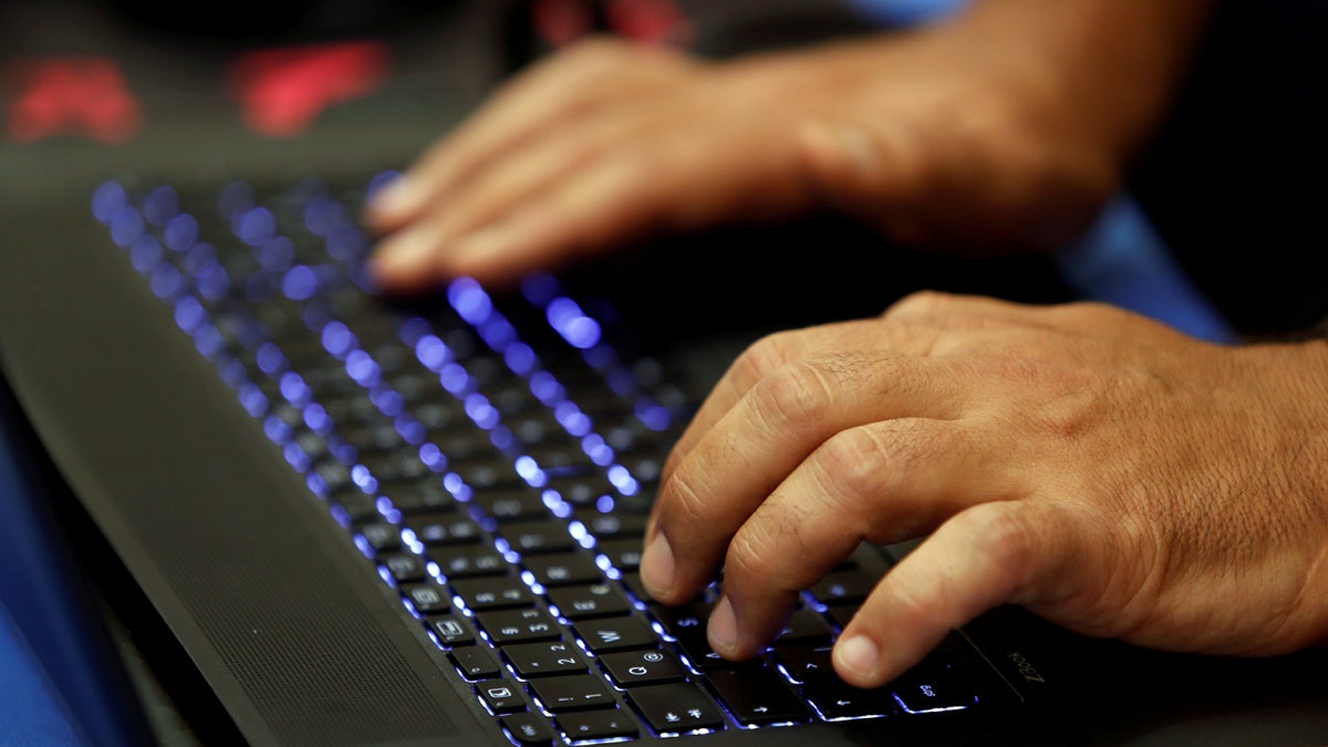 A man types into a keyboard during the Def Con hacker convention in Las Vegas, Nevada, U.S. on July 29, 2017. REUTERS/Steve Marcus - RC1DDD0E29A0