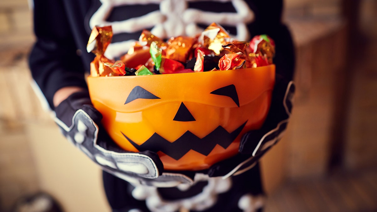 A photo of a bowl of Halloween candy