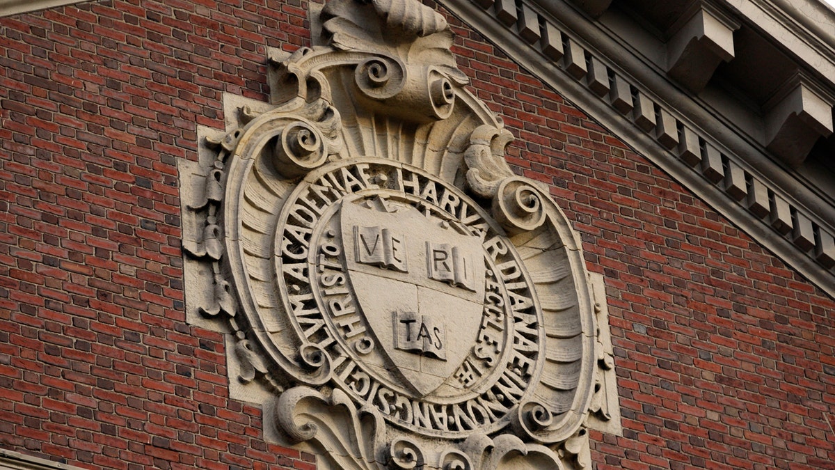 A seal hangs over a building at Harvard University in Cambridge, Massachusetts November 16, 2012. REUTERS/Jessica Rinaldi (UNITED STATES - Tags: EDUCATION) - RTR3AIAS