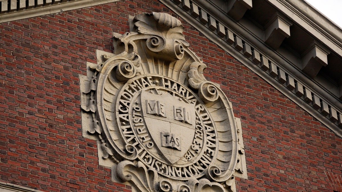 A seal hangs over a building at Harvard University in Cambridge, Massachusetts November 16, 2012. REUTERS/Jessica Rinaldi (UNITED STATES - Tags: EDUCATION) - RTR3AIAS