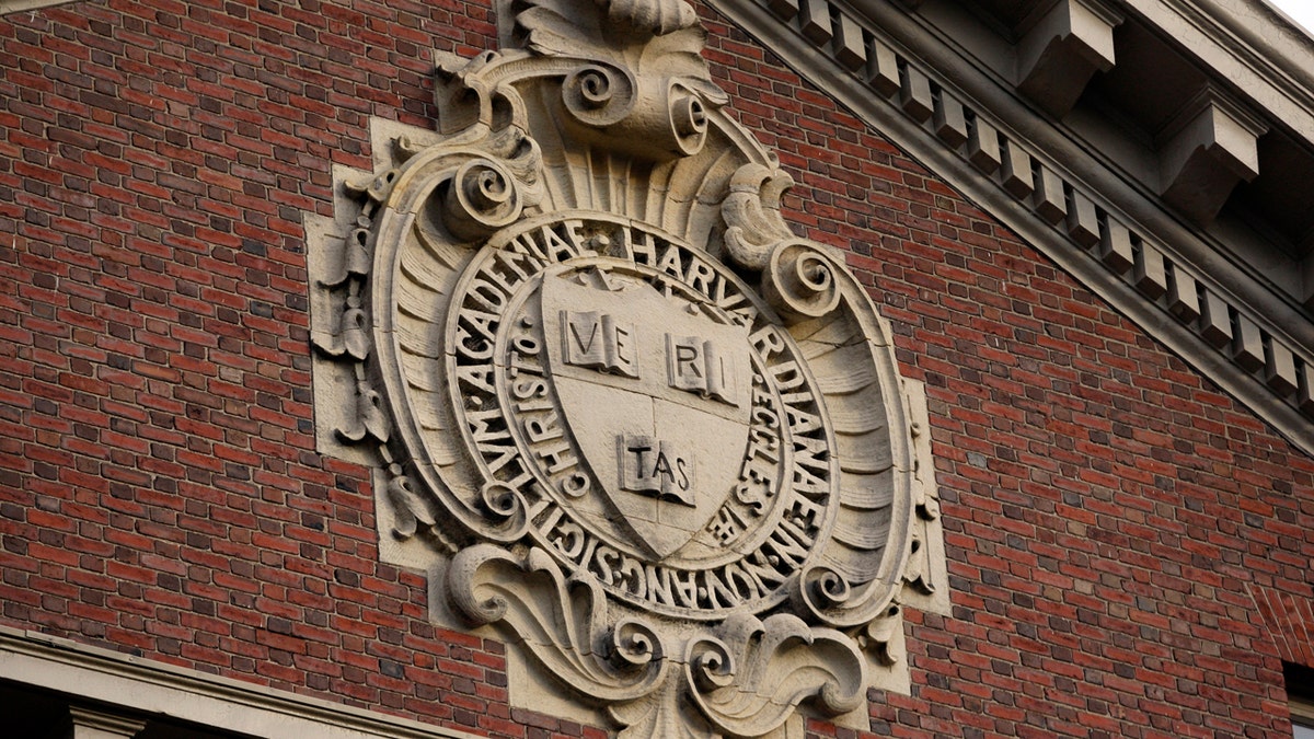 A seal hangs over a building at Harvard University in Cambridge, Massachusetts November 16, 2012. REUTERS/Jessica Rinaldi (UNITED STATES - Tags: EDUCATION) - TM3E8BG1EZ201