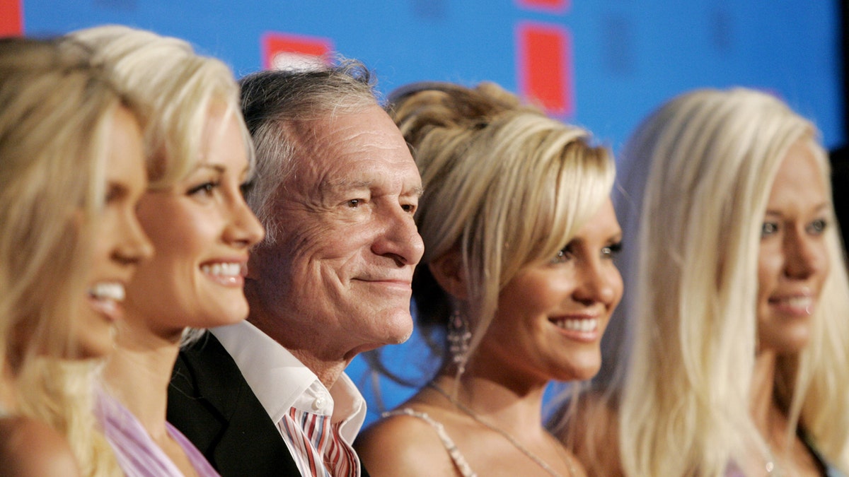 Playboy founder Hugh Hefner and his three girlfriends Holly Madison (2nd L), Bridget Marquardt (2nd R) and Kendra Wilkinson (R) arrive at the E! Entertainment television summer splash party at the Tropicana bar at the Roosevelt hotel in Hollywood, Aug. 1, 2005.