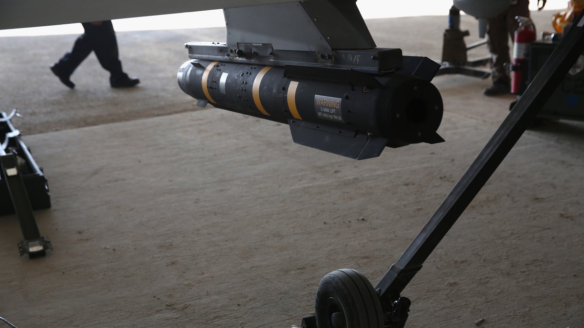 UNSPECIFIED, UNSPECIFIED - JANUARY 07:  A Hellfire missile hangs from a U.S. Air Force MQ-1B Predator unmanned aerial vehicle (UAV), at a secret air base in the Persian Gulf region on January 7, 2016. The U.S. military and coalition forces use the base, located in an undisclosed location, to launch drone airstrikes against ISIL in Iraq and Syria, as well as to transport cargo and troops supporting Operation Inherent Resolve. The Predators at the base are operated and maintained by the 46th Expeditionary Reconnaissance Squadron, currently attached to the 386th Air Expeditionary Wing.  (Photo by John Moore/Getty Images)