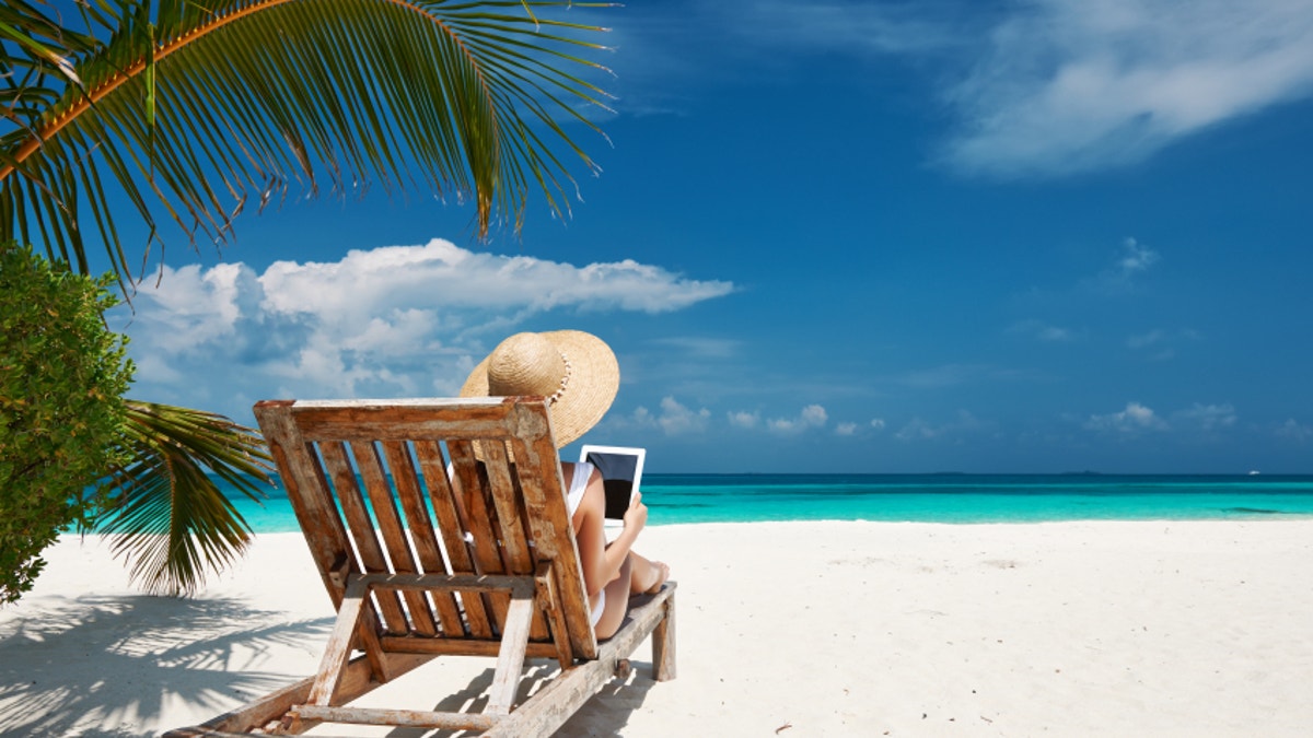 Young woman with tablet pc at the beach