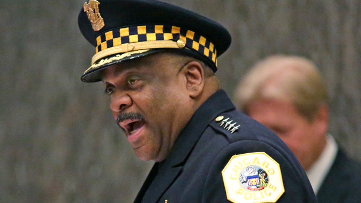 FILE - In this April 13, 2016, file photo, Eddie Johnson, left, speaks after being sworn in as the new Chicago police superintendent in Chicago. After a month in which nearly 15 people were shot every day,  Johnson announced Friday, July 1, 2016, a July 4 weekend show of force that will include thousands more officers on the streets than usual, officers toting high-powered weapons at airports and teams of officers patrolling the city's most dangerous neighborhoods, tourist attractions, train stations and parks. (AP Photo/M. Spencer Green, File)