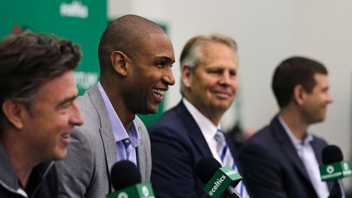 Boston Celtics forward Al Horford, second from left, smiles during a media availability at the team's practice facility, Friday, July 8, 2016, in Waltham, Mass. Horford agreed to a four-year, $113 million deal with the Celtics as an unrestricted free agent, ending nearly ten years with the Atlanta Hawks. From left are Celtics owner Wyc Grousbeck, Horford, general manager Danny Ainge and head coach Brad Stevens. (AP Photo/Charles Krupa)