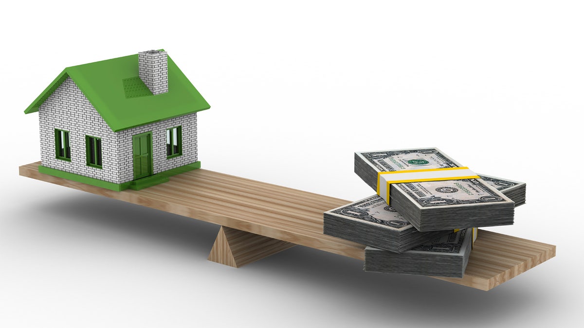 house and money on scales. Isolated 3D image