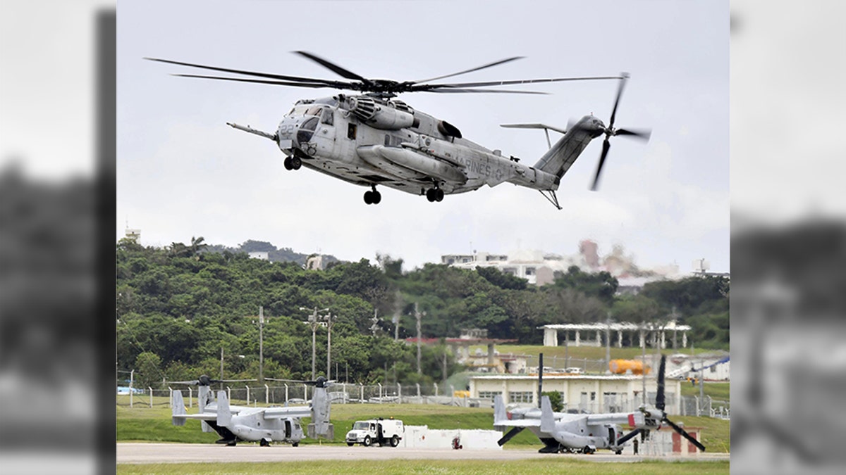 This Oct. 2017 photo shows U.S. Forces' CH53E helicopter in Ginowan, Okinawa. A metal window frame has fallen from a U.S. military aircraft in flight and landed on a school playground on Okinawa, leaving a boy with minor injury from small gravels stirred up from the ground and escalating anti-American base sentiment on the southern island. (Ryosuke Uematsu/Kyodo News via AP)