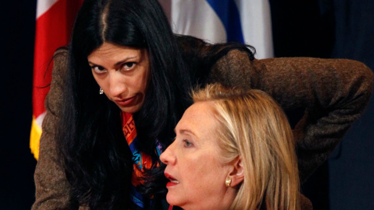 Sept. 20, 2011: U.S. Secretary of State Hillary Clinton talks with her deputy chief of staff, Huma Abedin, during the Open Government Partnership event in New York. (Reuters)