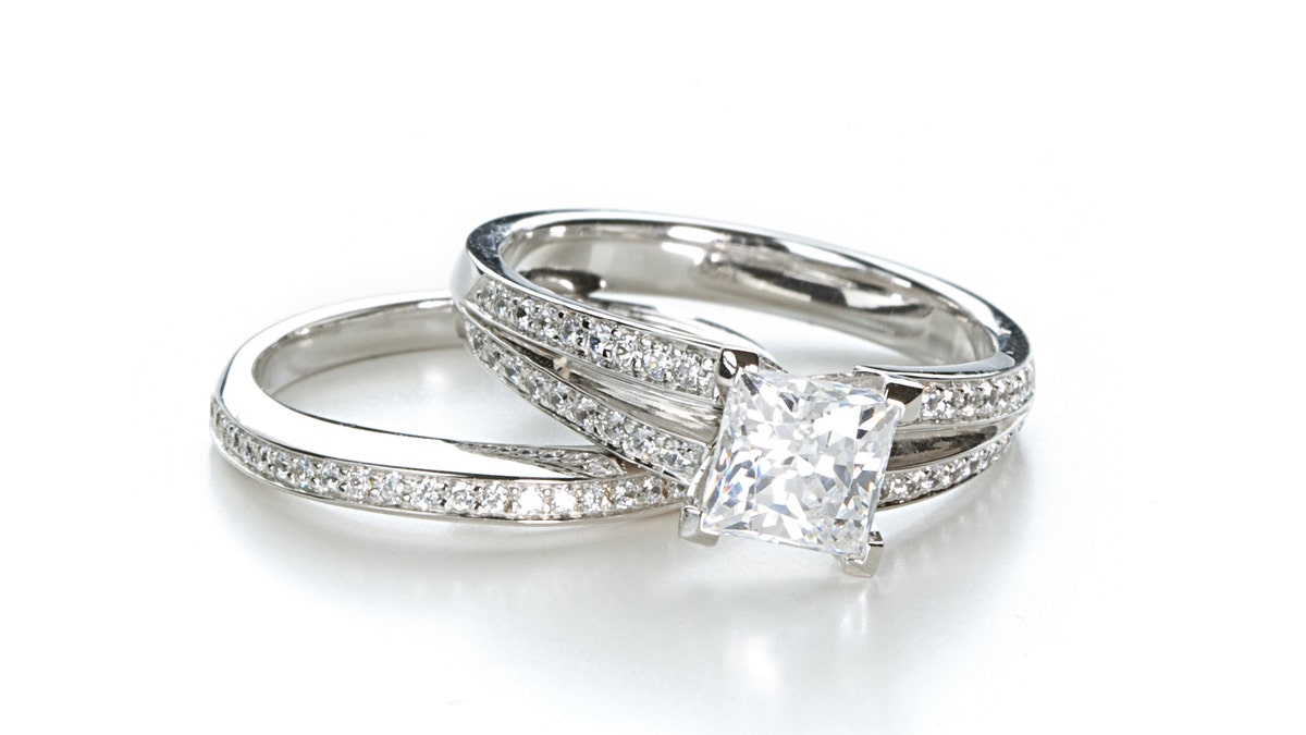 An engagement ring with a princess cut diamond and a wedding band.Click the image for jewelry and gemstone photos: