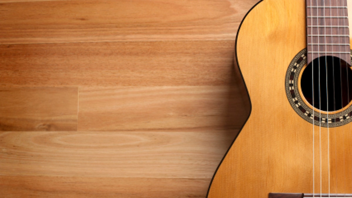 Acoustic guitar with wood background