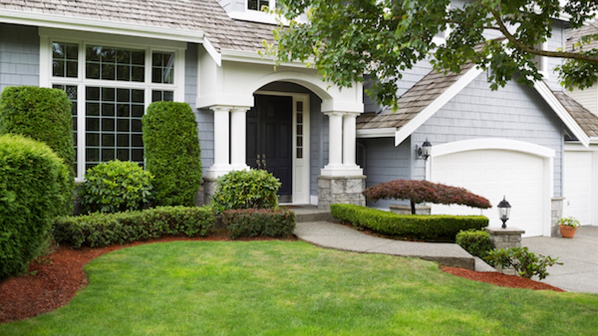 Newly painted and stained exterior of modern home during summertime