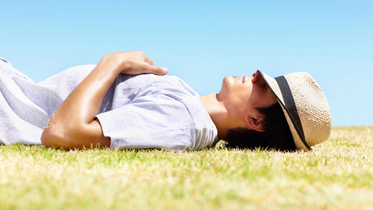 Young man resting in hot sun - Outdoor