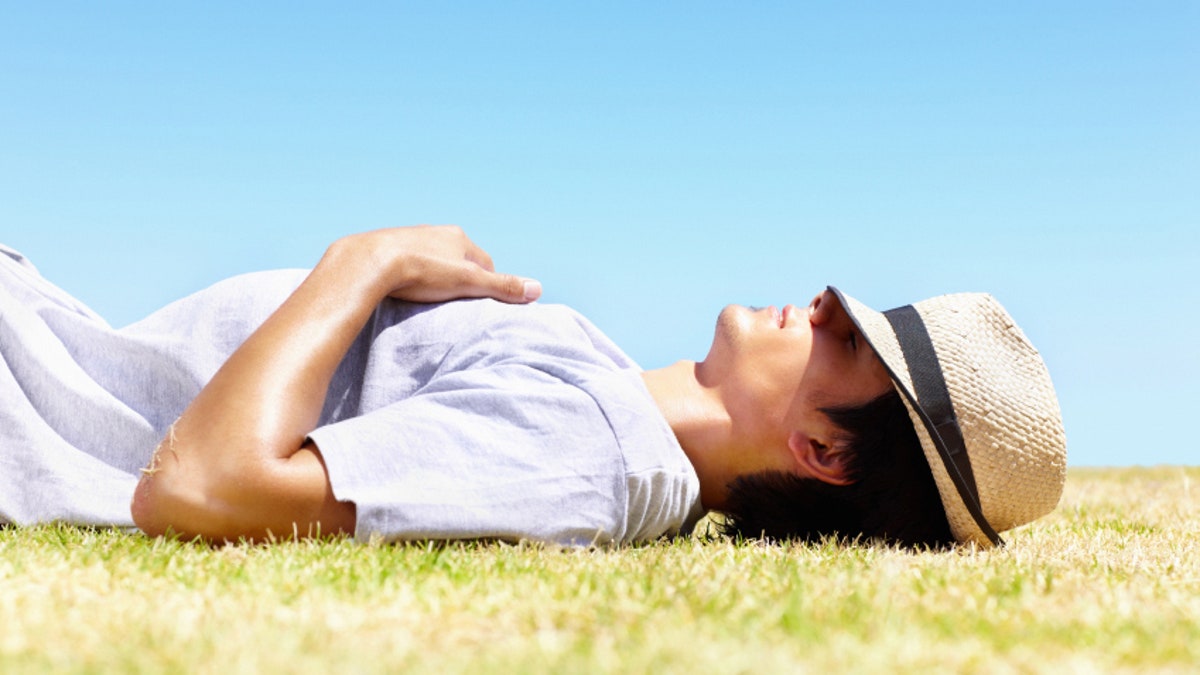 Young man resting in hot sun - Outdoor