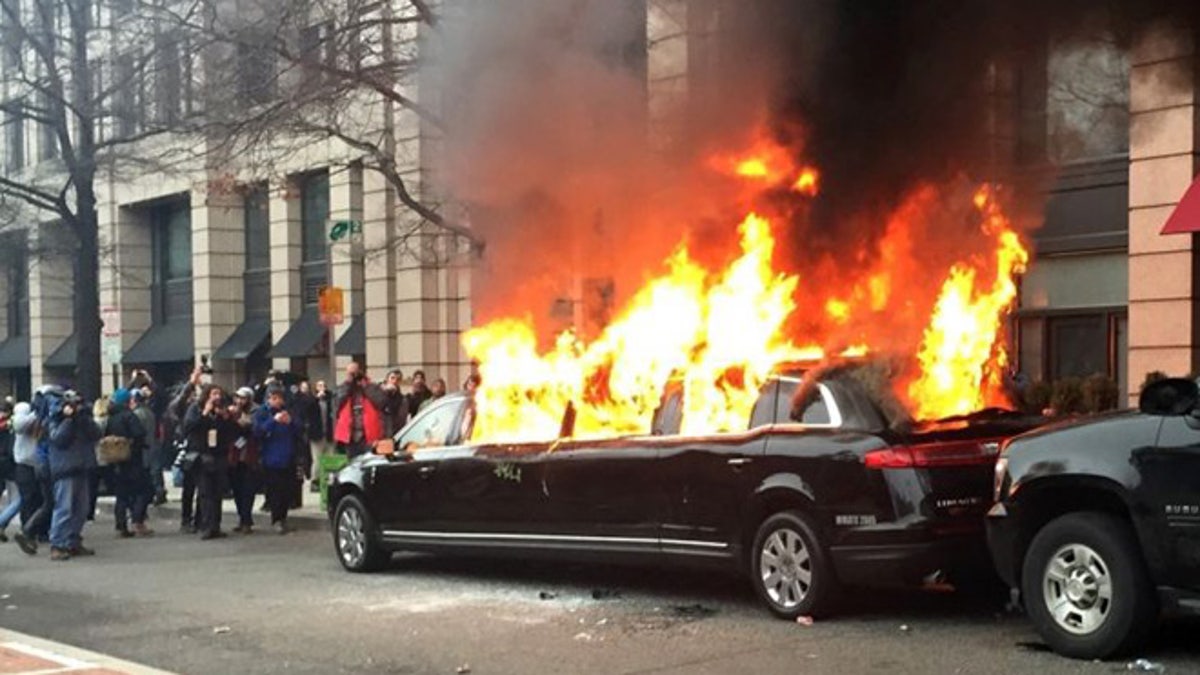 Protesters set a parked limousine on fire in downtown Washington, Friday, Jan. 20, 2017, during the inauguration of President Trump.