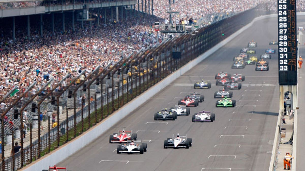 The 33-car field led by Helio Castroneves, of Brazil, heads to the first turn to start the Indianapolis 500 auto race at the Indianapolis Motor Speedway in Indianapolis, Sunday, May 30, 2010.
