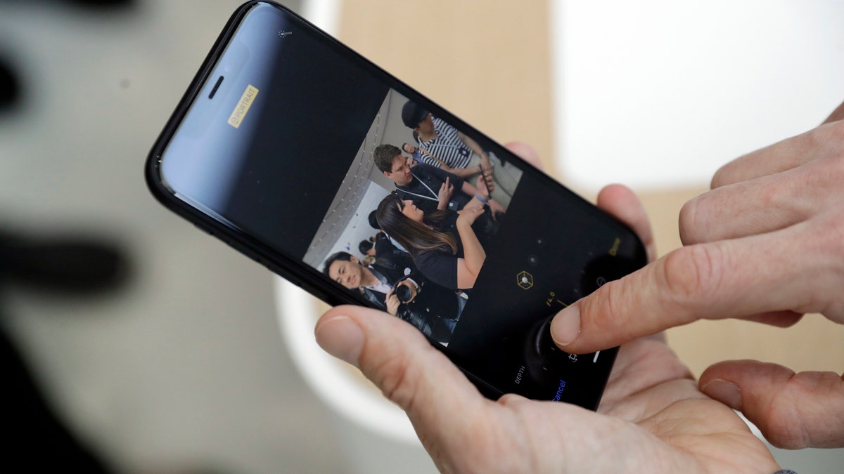 The new picture controls features are shown on an iPhone XR during an event to announce new products Wednesday, Sept. 12, 2018, in Cupertino, Calif. (AP Photo/Marcio Jose Sanchez)