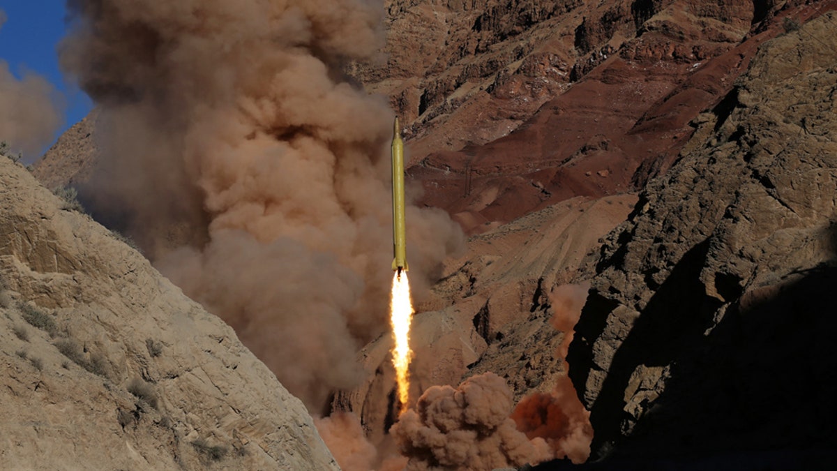 In this photo obtained from the Iranian Fars News Agency, a Qadr H long-range ballistic surface-to-surface missile is fired by Iran's powerful Revolutionary Guard, during a maneuver, in an undisclosed location in Iran, Wednesday, March 9, 2016. Irans powerful Revolutionary Guard test-fired two ballistic missiles Wednesday with the phrase "Israel must be wiped out" written on them, a show of deterrence power by the Islamic Republic as U.S. Vice President Joe Biden visited Israel, the semi-official Fars news agency reported. (AP Photo/Fars News Agency, Omid Vahabzadeh)