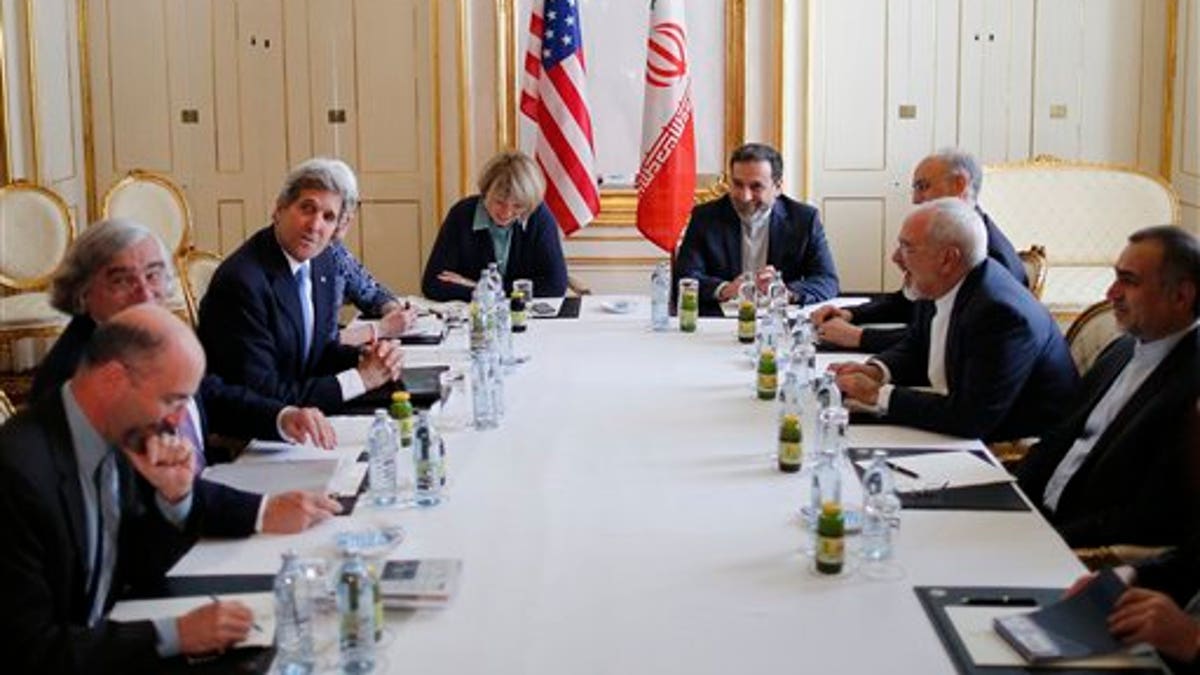 U.S. Secretary of State John Kerry, 3rd left, meets with Iranian Foreign Minister Javad Zarif, 2nd right, at an hotel in Vienna, Wednesday July 1, 2015. The head of the U.N. agency tasked to monitor a nuclear deal is traveling to Tehran to meet with Iranian President Hassan Rouhani, the agency said Wednesday. (Carlos Barria/Pool Photo via AP) 