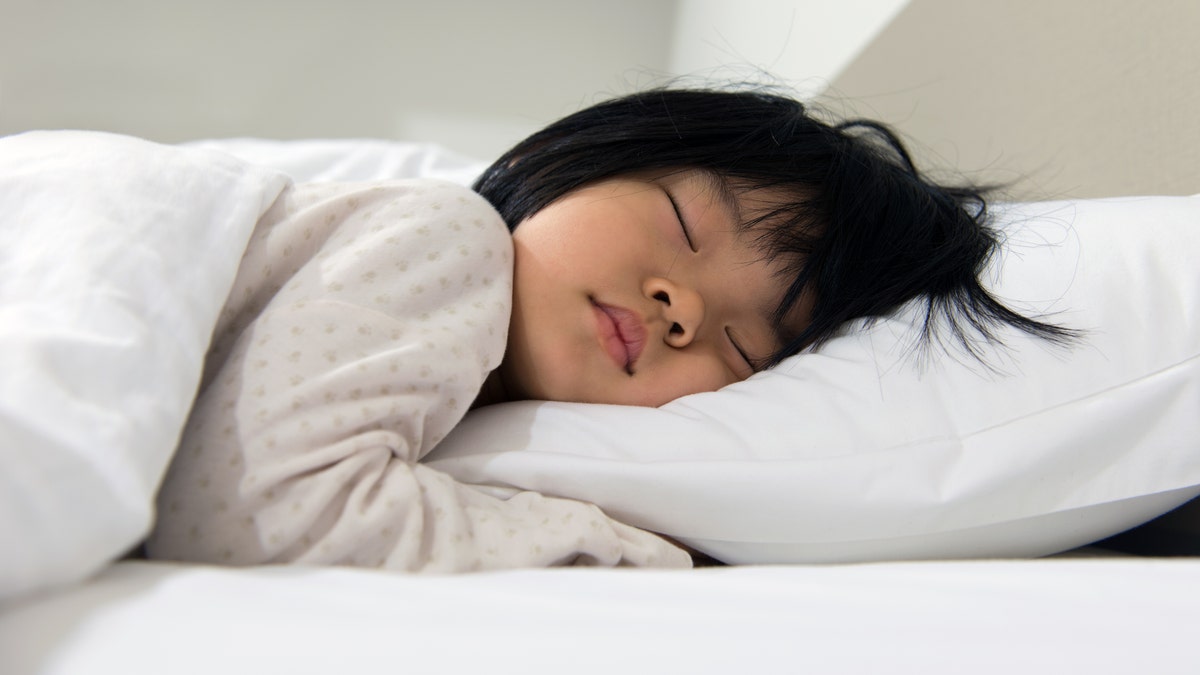 Child sleeping on a bed