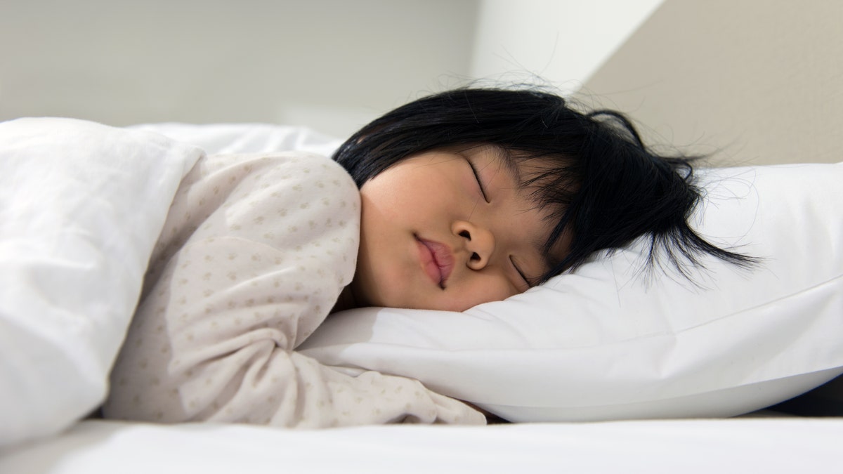 Child sleeping on a bed