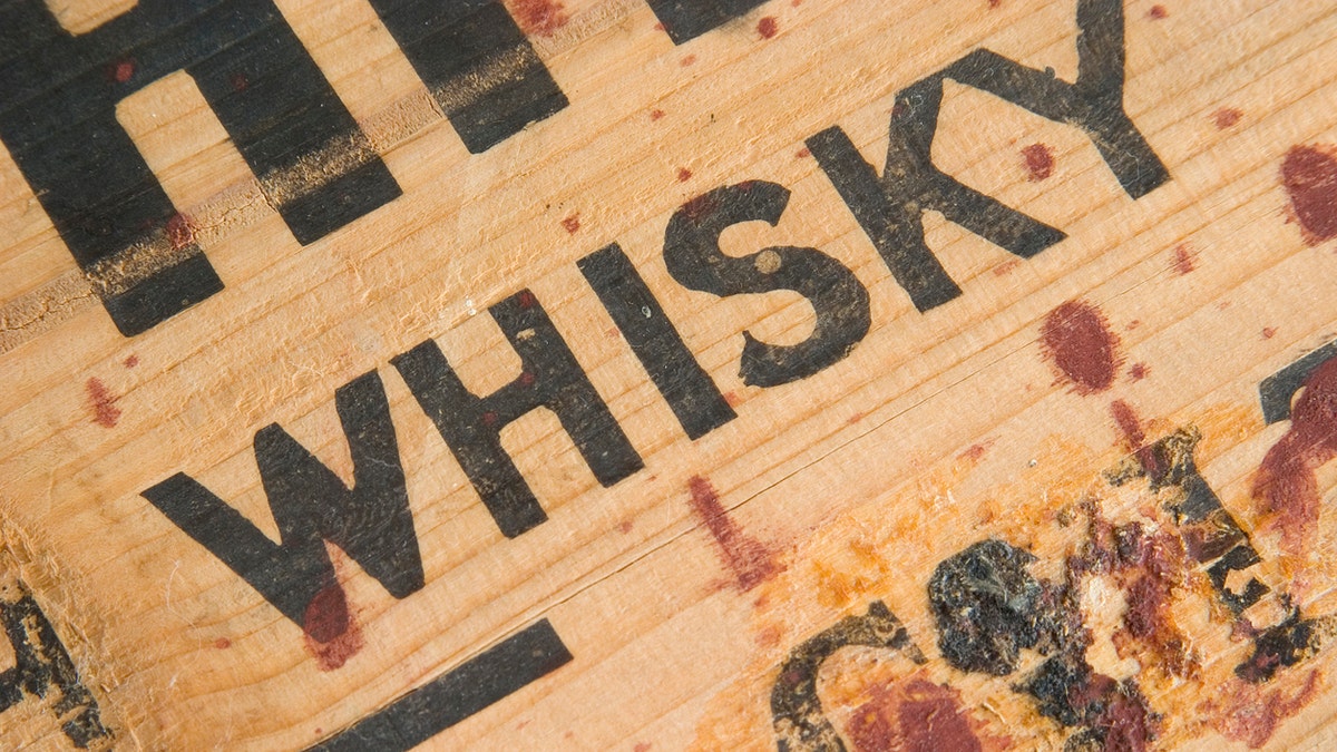 Closeup detail of an antique whiskey box with gunk. Sharp. Processed RAW.