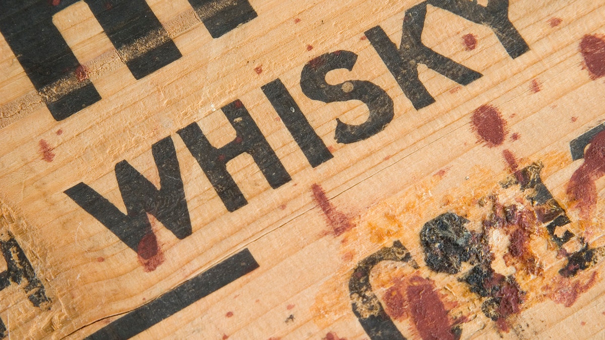 Closeup detail of an antique whiskey box with gunk. Sharp. Processed RAW.