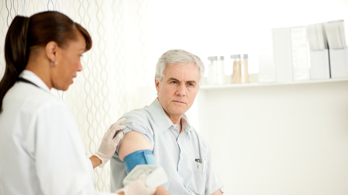 man_blood_pressure_doctor_istock