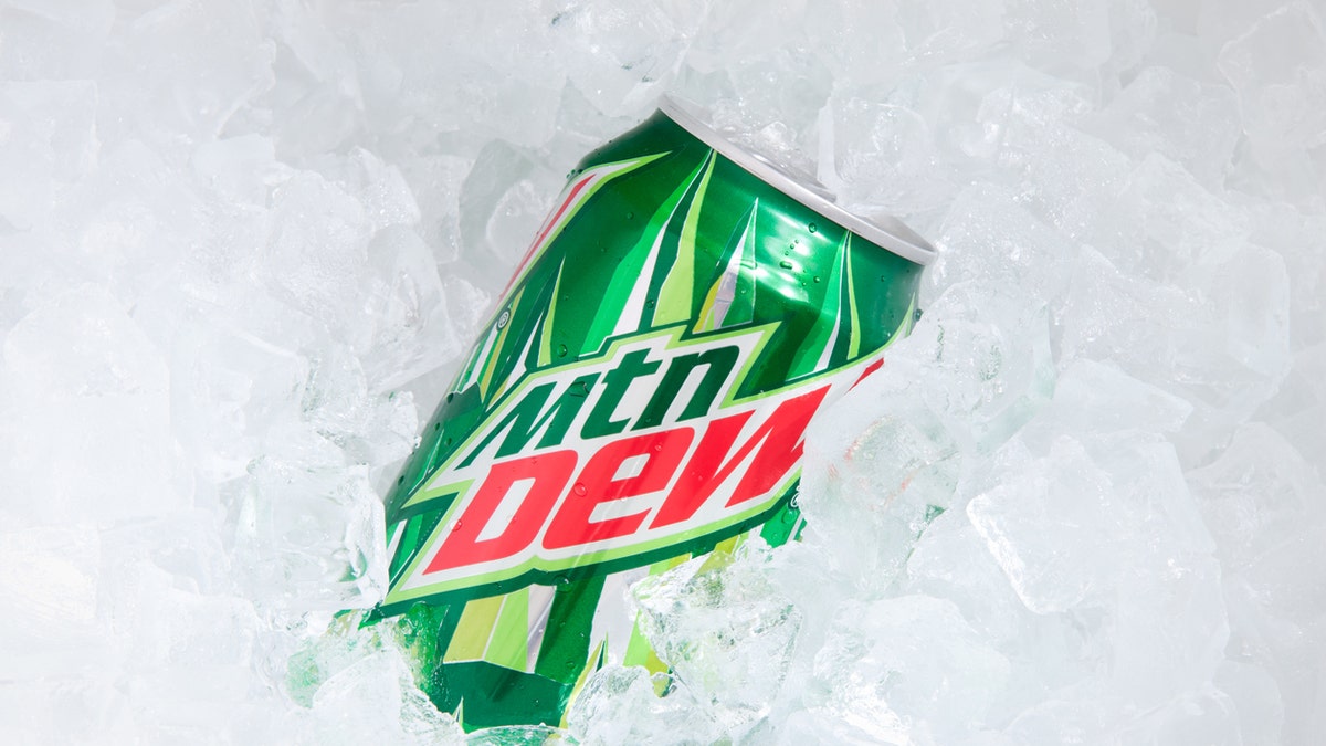 "Orlando, USA - November 8, 2011: A can of Mountain Dew buried in ice cubes. Focus on the can. Mountain Dew is a soft drink produced by Pepsi-Co . It contains caffeine. The drink was introduced in the 1960s."