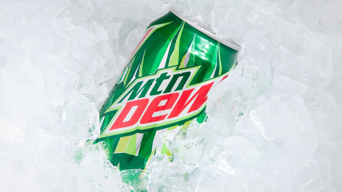 "Orlando, USA - November 8, 2011: A can of Mountain Dew buried in ice cubes. Focus on the can. Mountain Dew is a soft drink produced by Pepsi-Co . It contains caffeine. The drink was introduced in the 1960s."