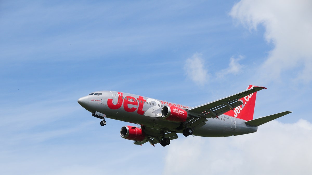 Jersey, U.K. - June 7, 2014: Jet2 a British budget company flying a commercial Boeing 737-300 jet, a nationwide airliner, landing at Jersey airport.