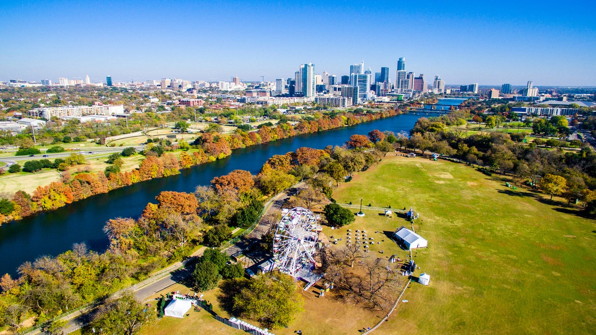 Changing Colors Along Colorado River Aerial Shot Flying over Zilker Park in Austin , Texas with the trail of lights display ready for Christmas. December brings changing of seasons and the dropping of leaves in Central Texas