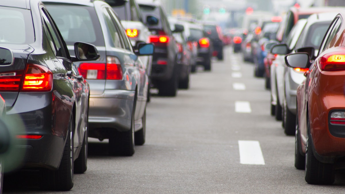 Cars in long row on highway in traffic jam