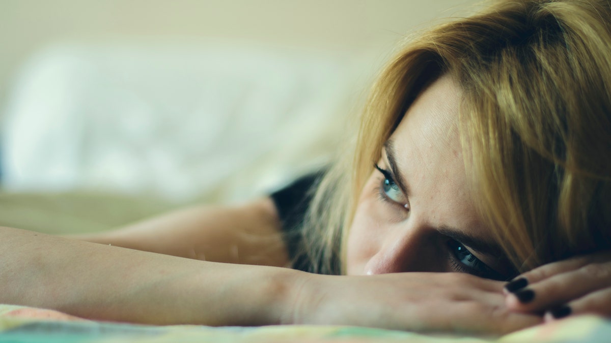 Beautiful woman laying down in a bed