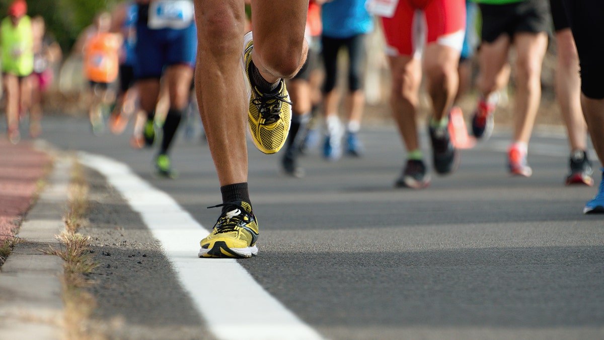 Marathon running race, people feet on city road