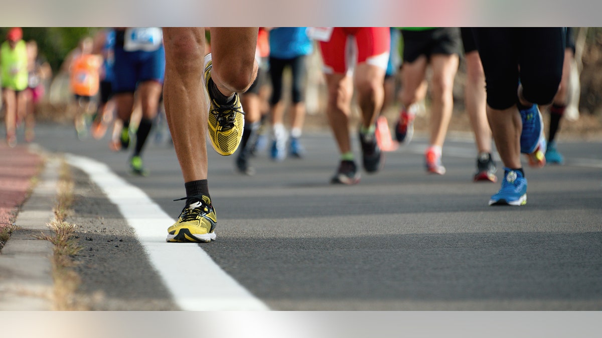 Marathon running race, people feet on city road