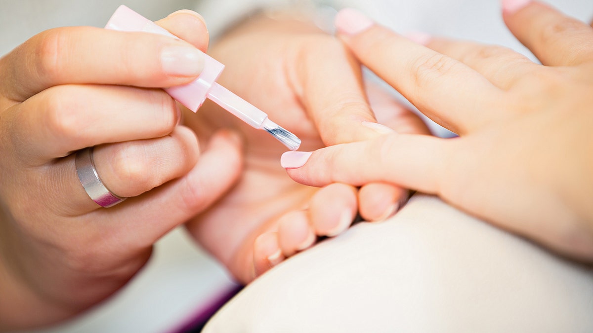 Close Up Of Woman Hand At The Beauty Salon Getting A Manicure