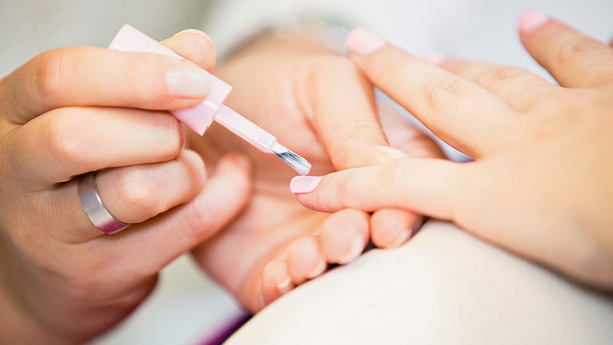 Close Up Of Woman Hand At The Beauty Salon Getting A Manicure