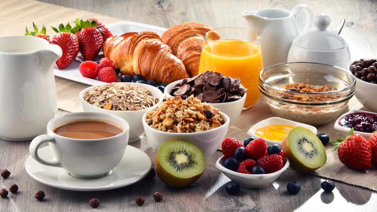 Breakfast served with coffee, orange juice, croissants, cereals and fruits. Balanced diet.