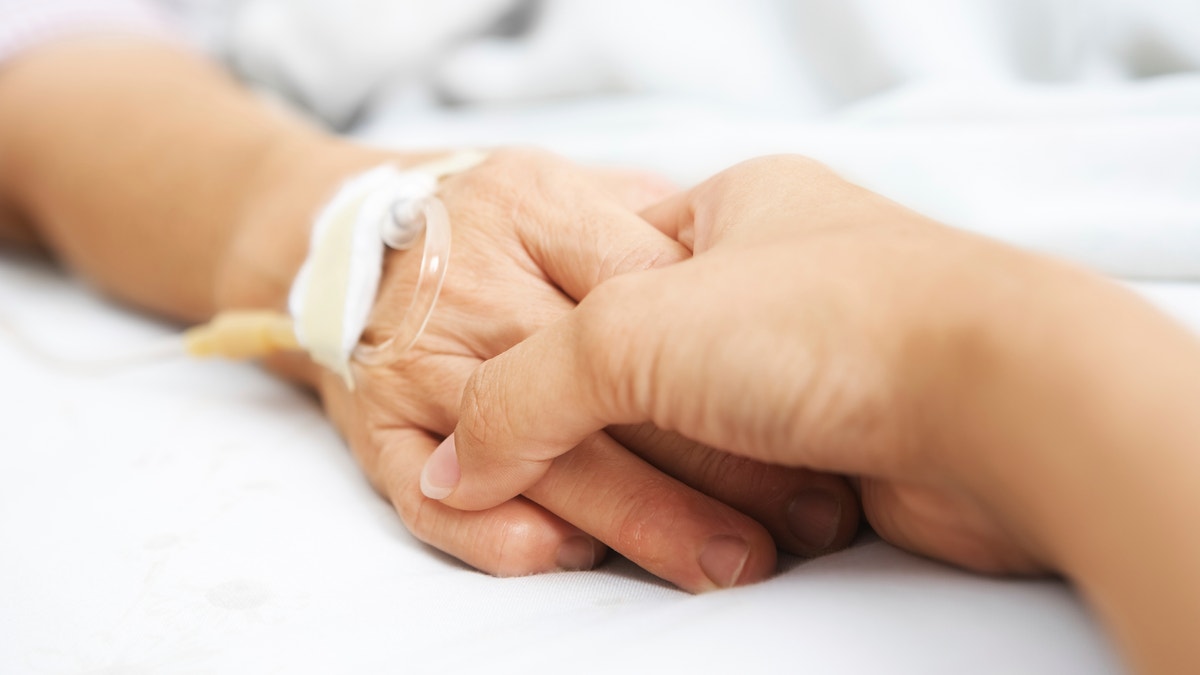 holding_hands_hospital_bed_istock