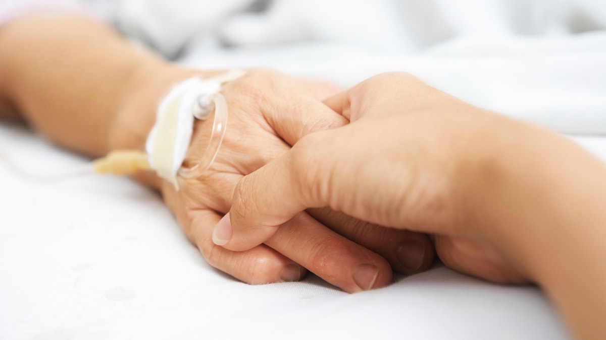 holding_hands_hospital_bed_istock