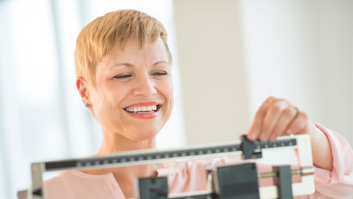 woman_scale_happy_weight_loss_istock