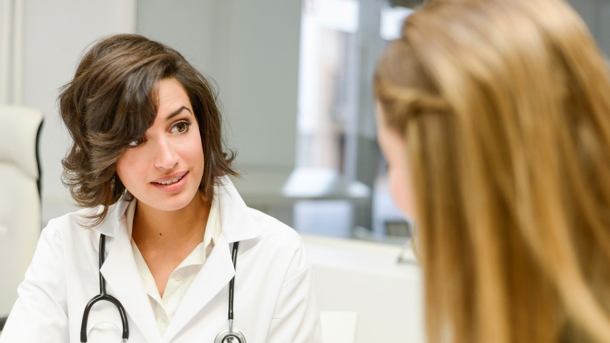 young_woman_doctor_office_istock